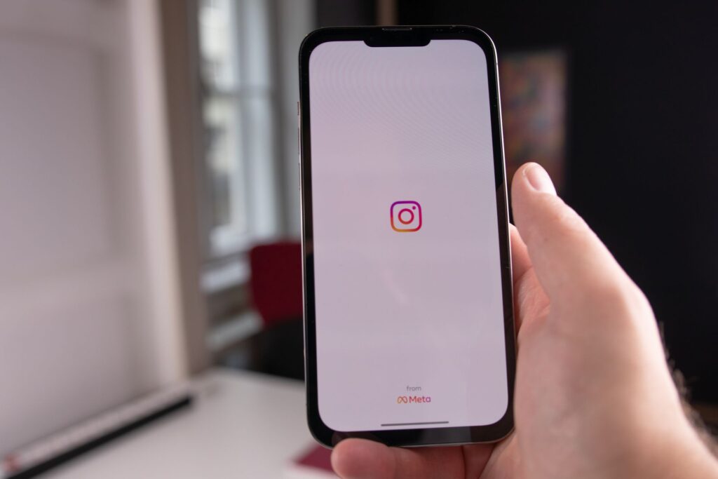 Person opening Instagram on their phone to check real followers and engagement