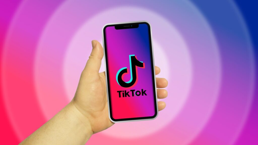 Person opening the TikTok app on their phone to grow followers